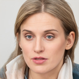 Joyful white young-adult female with long  brown hair and blue eyes