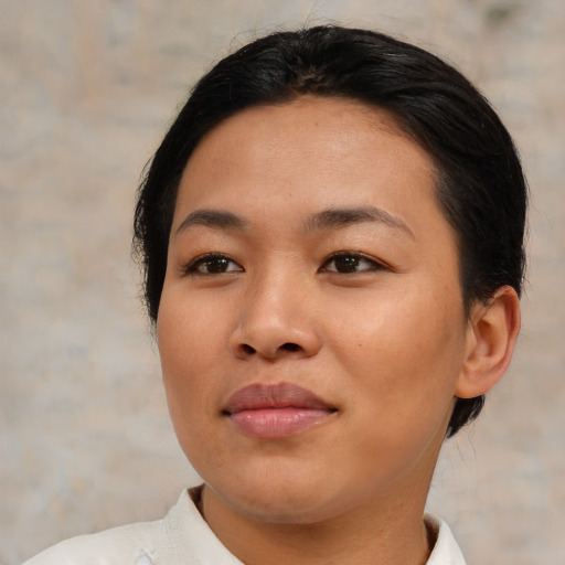 Joyful asian young-adult female with medium  brown hair and brown eyes