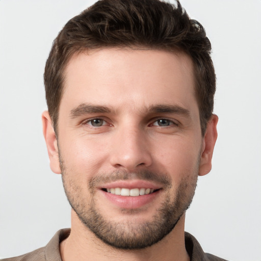 Joyful white young-adult male with short  brown hair and brown eyes