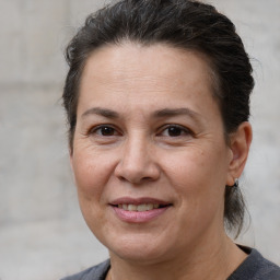 Joyful white adult female with medium  brown hair and brown eyes