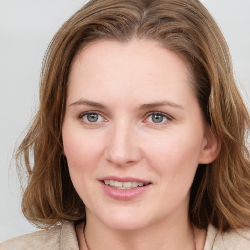 Joyful white young-adult female with medium  brown hair and blue eyes