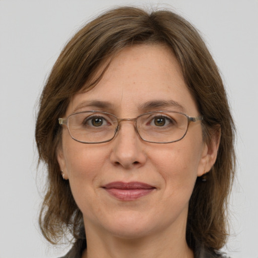 Joyful white adult female with medium  brown hair and grey eyes