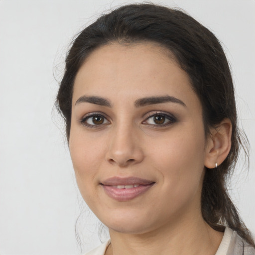 Joyful latino young-adult female with medium  brown hair and brown eyes