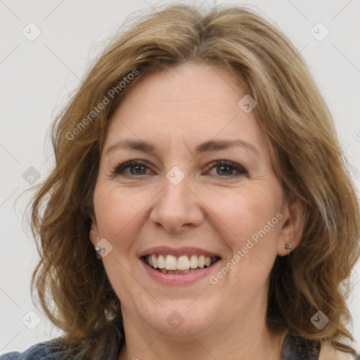 Joyful white adult female with medium  brown hair and grey eyes