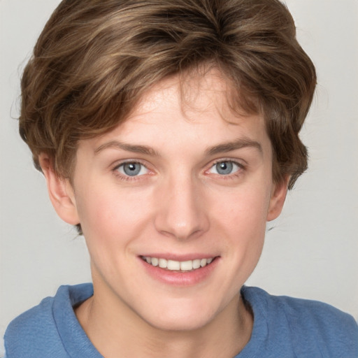 Joyful white young-adult female with short  brown hair and blue eyes