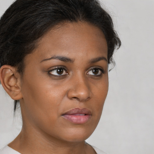 Neutral black young-adult female with medium  brown hair and brown eyes
