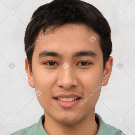 Joyful asian young-adult male with short  brown hair and brown eyes