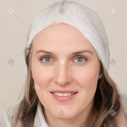 Joyful white young-adult female with medium  brown hair and blue eyes