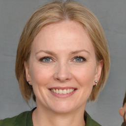 Joyful white young-adult female with medium  brown hair and blue eyes