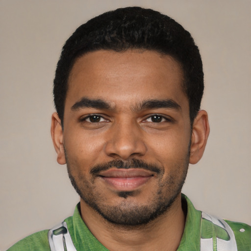Joyful black young-adult male with short  black hair and brown eyes