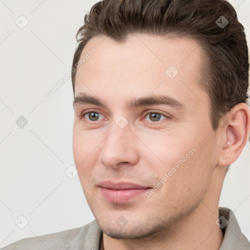 Joyful white young-adult male with short  brown hair and brown eyes