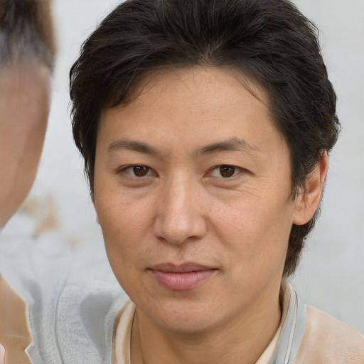 Joyful white adult female with short  brown hair and brown eyes