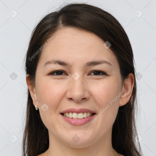 Joyful white young-adult female with long  brown hair and brown eyes