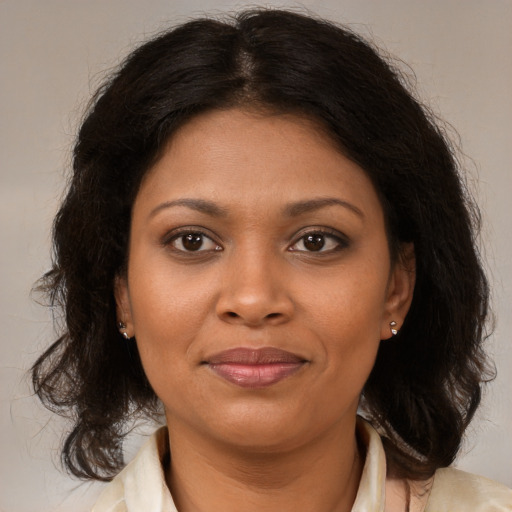 Joyful black young-adult female with medium  brown hair and brown eyes