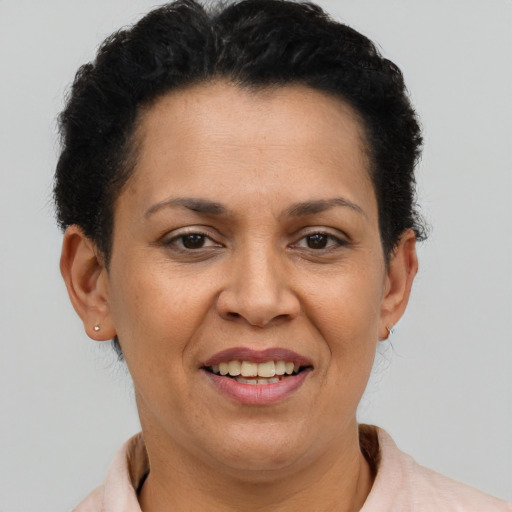 Joyful latino adult female with short  brown hair and brown eyes
