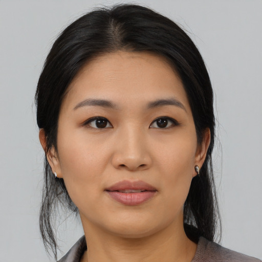 Joyful asian young-adult female with medium  black hair and brown eyes