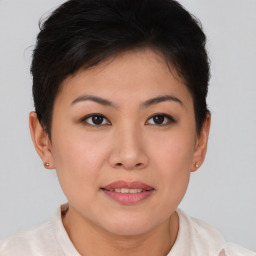 Joyful asian young-adult female with short  brown hair and brown eyes