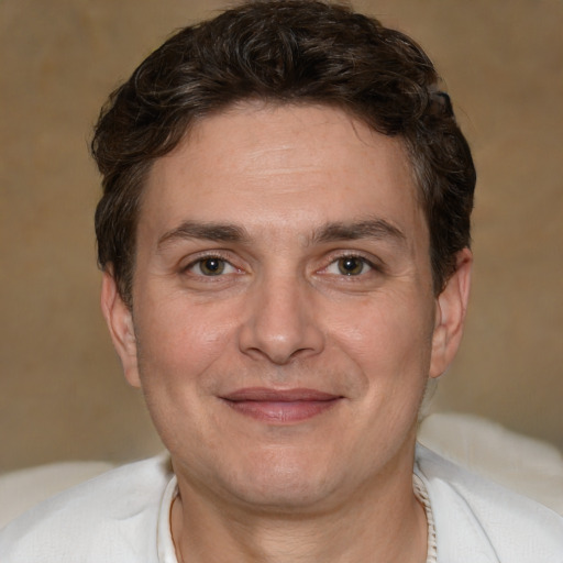 Joyful white adult male with short  brown hair and brown eyes