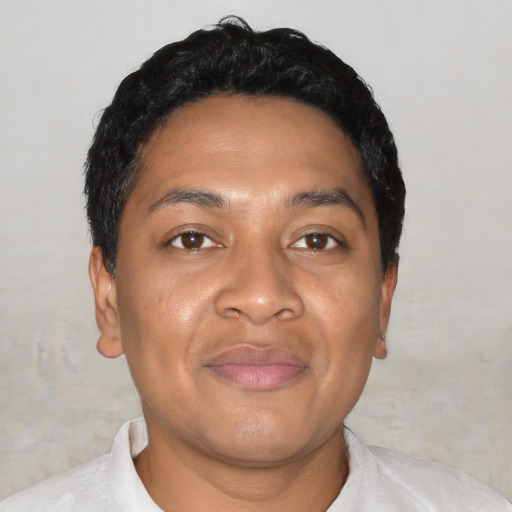 Joyful latino young-adult male with short  brown hair and brown eyes