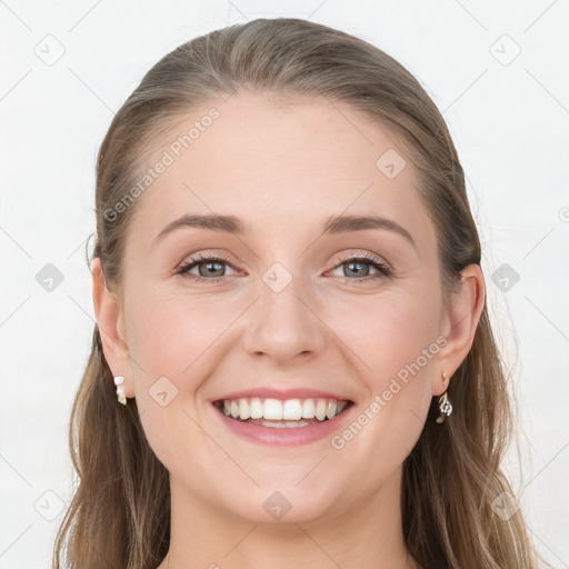 Joyful white young-adult female with long  brown hair and grey eyes