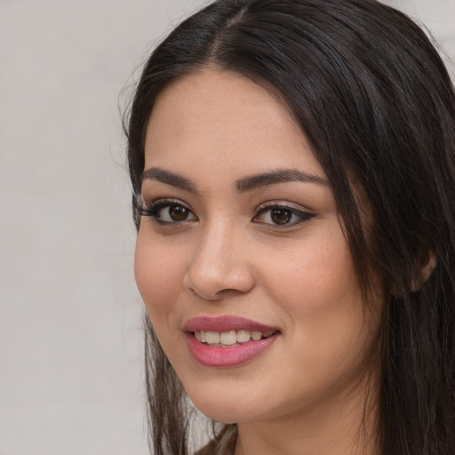 Joyful white young-adult female with long  black hair and brown eyes