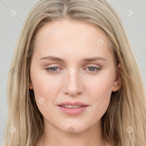 Joyful white young-adult female with long  brown hair and blue eyes