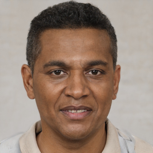 Joyful black adult male with short  brown hair and brown eyes