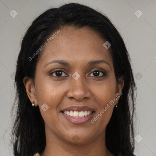 Joyful black young-adult female with long  brown hair and brown eyes