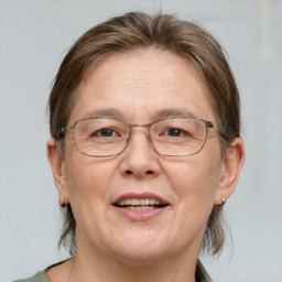 Joyful white adult female with medium  brown hair and blue eyes