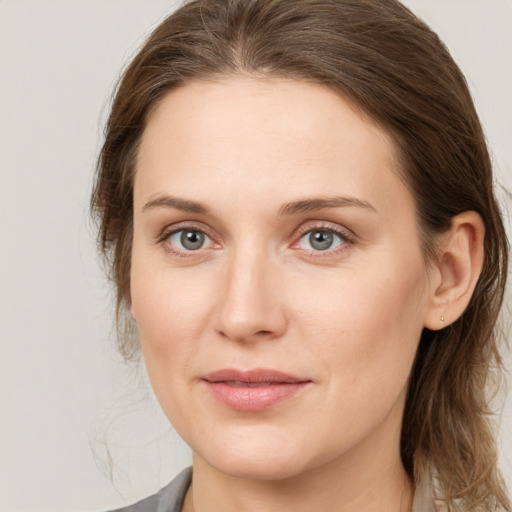 Joyful white young-adult female with long  brown hair and grey eyes