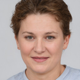 Joyful white adult female with short  brown hair and grey eyes