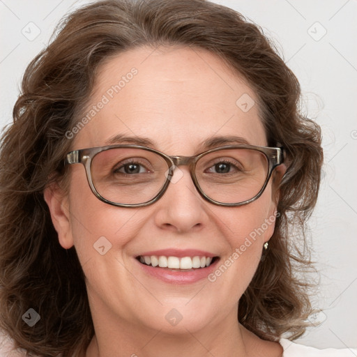 Joyful white adult female with medium  brown hair and blue eyes