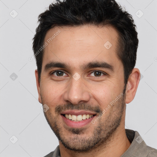 Joyful white young-adult male with short  black hair and brown eyes