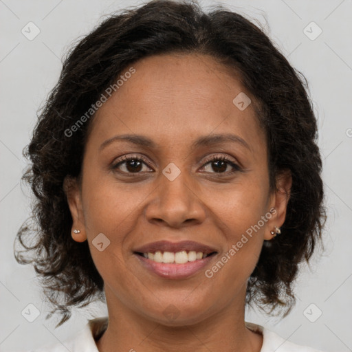 Joyful black adult female with medium  brown hair and brown eyes