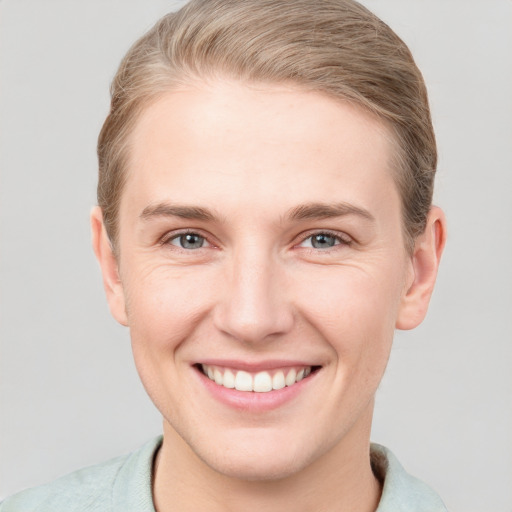 Joyful white young-adult female with short  brown hair and grey eyes