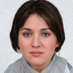 Joyful white young-adult female with medium  brown hair and blue eyes