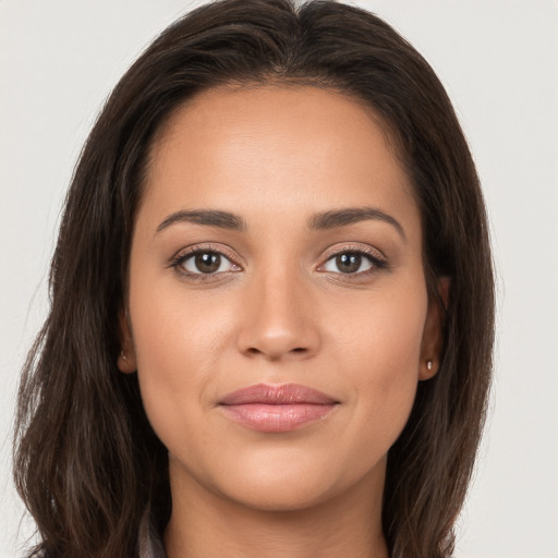 Joyful white young-adult female with long  brown hair and brown eyes