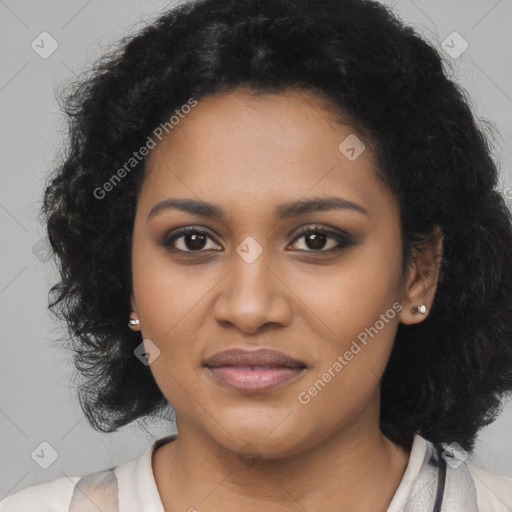 Joyful black young-adult female with long  brown hair and brown eyes