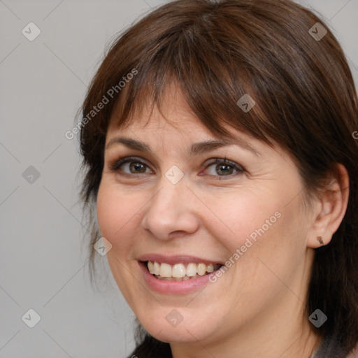 Joyful white adult female with medium  brown hair and brown eyes