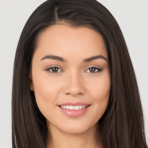 Joyful white young-adult female with long  brown hair and brown eyes