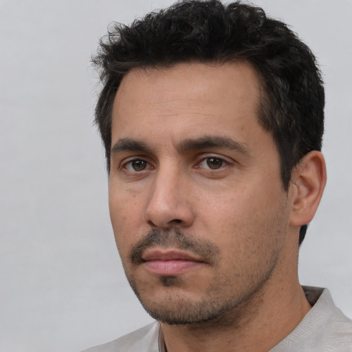 Neutral white adult male with short  black hair and brown eyes