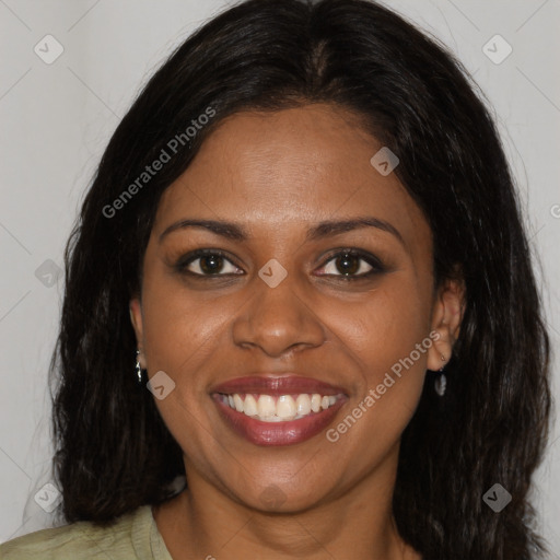 Joyful black young-adult female with long  brown hair and brown eyes