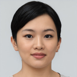 Joyful asian young-adult female with short  black hair and brown eyes