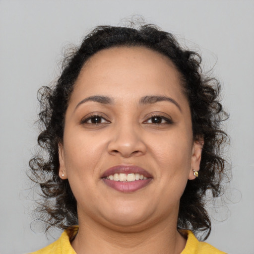 Joyful latino young-adult female with medium  brown hair and brown eyes
