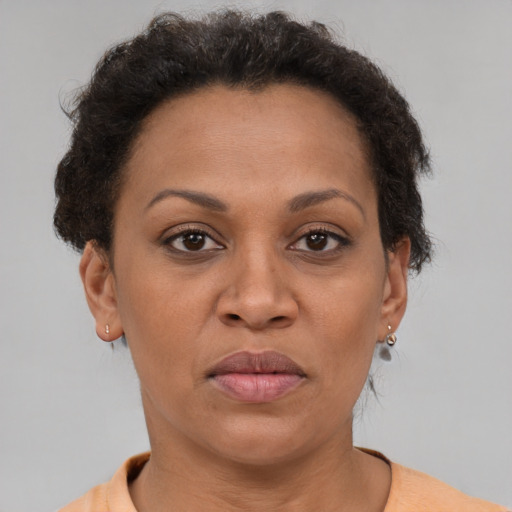 Joyful black adult female with short  brown hair and brown eyes