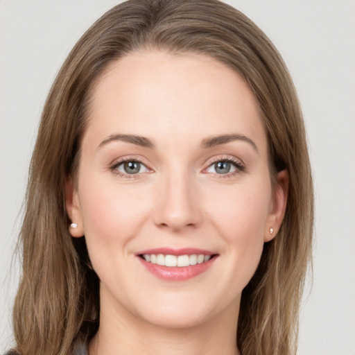 Joyful white young-adult female with long  brown hair and grey eyes