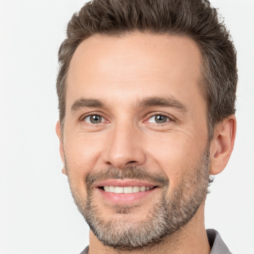 Joyful white adult male with short  brown hair and brown eyes