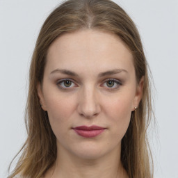 Joyful white young-adult female with long  brown hair and grey eyes