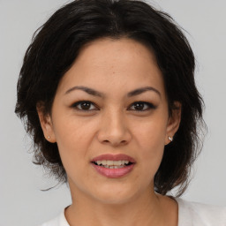 Joyful asian adult female with medium  brown hair and brown eyes