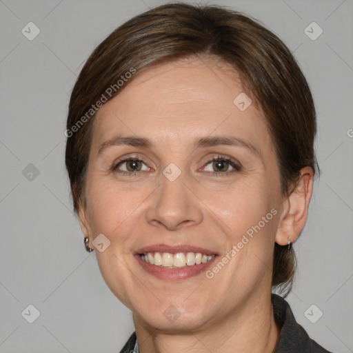 Joyful white adult female with medium  brown hair and brown eyes